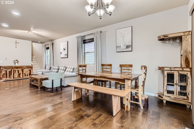 dining space with wood-type flooring and a chandelier