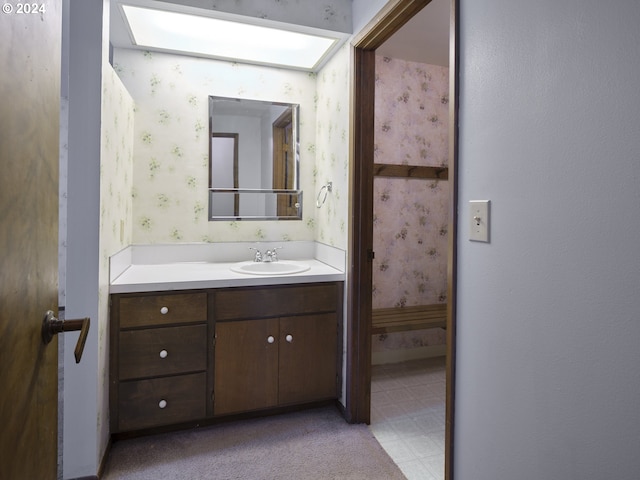 bathroom with vanity and a skylight