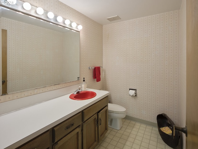 bathroom with toilet and vanity