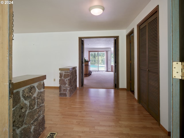 hallway featuring light hardwood / wood-style flooring