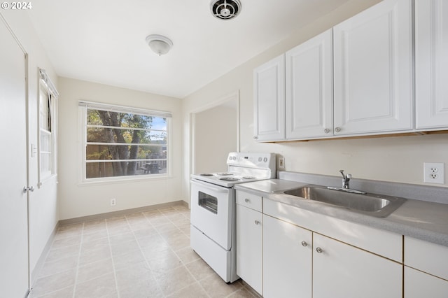 kitchen featuring white cabinetry, white electric stove, and sink