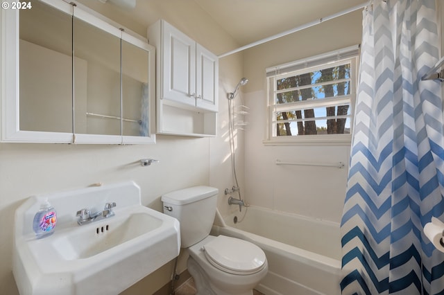 full bathroom with sink, shower / tub combo, and toilet