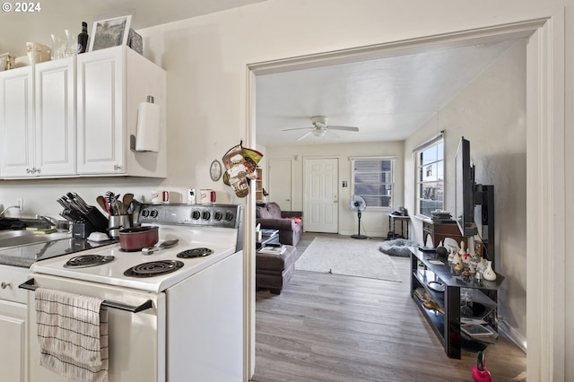 kitchen with light hardwood / wood-style flooring, white cabinets, ceiling fan, and white range with electric cooktop