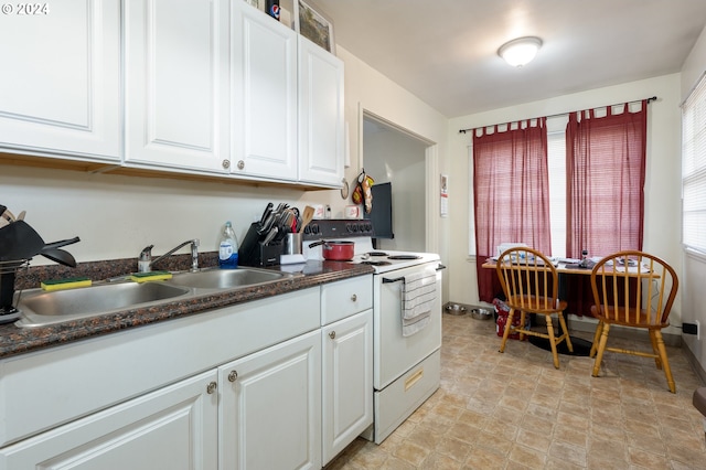 kitchen with white cabinets, white electric stove, and sink