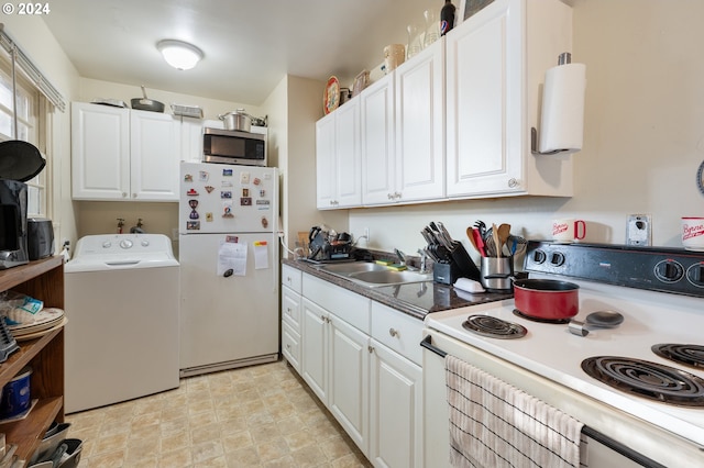 kitchen featuring sink, white cabinets, white appliances, and washer / clothes dryer