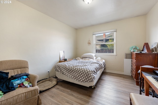 bedroom with hardwood / wood-style floors