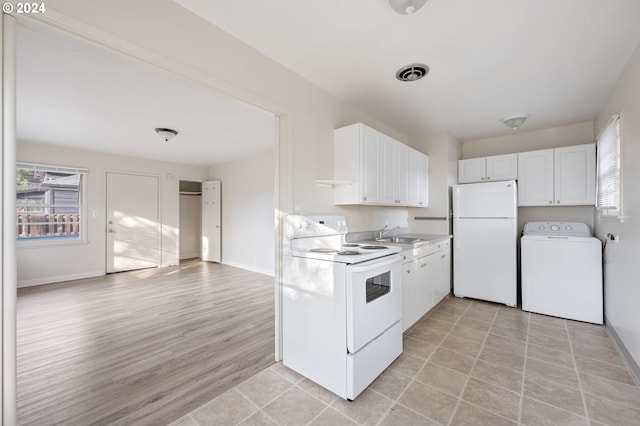 kitchen featuring white appliances, washer / clothes dryer, sink, light wood-type flooring, and white cabinets