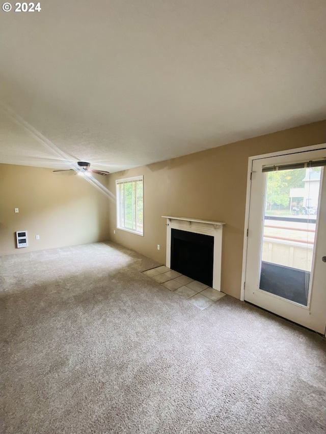 7161 Childs Rd, Lake Oswego, OR 97034 - unfurnished living room featuring carpet, a fireplace with flush hearth, heating unit, and a ceiling fan