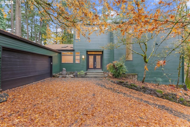 view of front of property with french doors and a garage