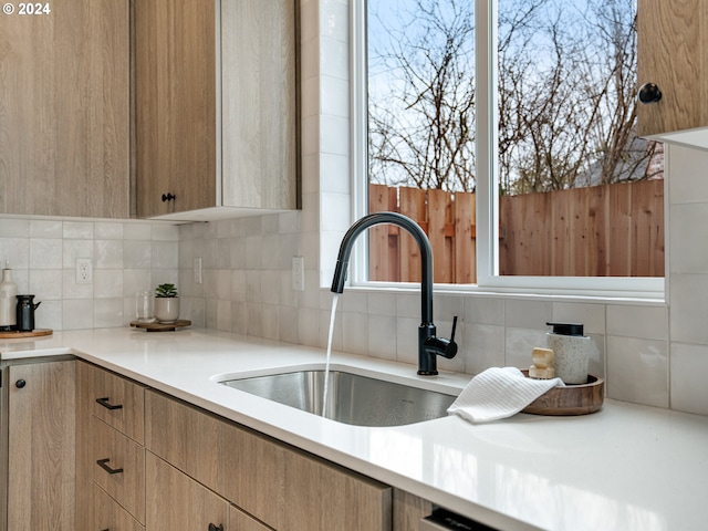 kitchen with plenty of natural light, sink, and tasteful backsplash