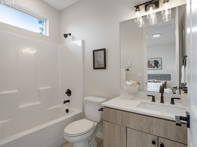 full bathroom featuring toilet, large vanity, and shower / bathing tub combination