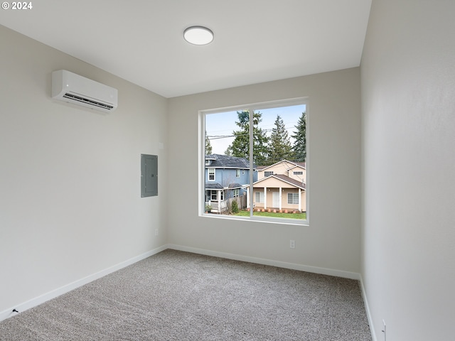 carpeted spare room featuring a wall unit AC