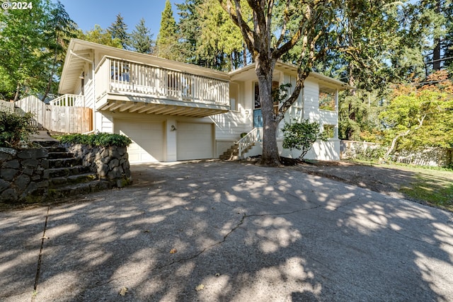 view of front of home with stairs, driveway, and a garage