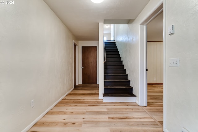 stairs with baseboards and wood finished floors