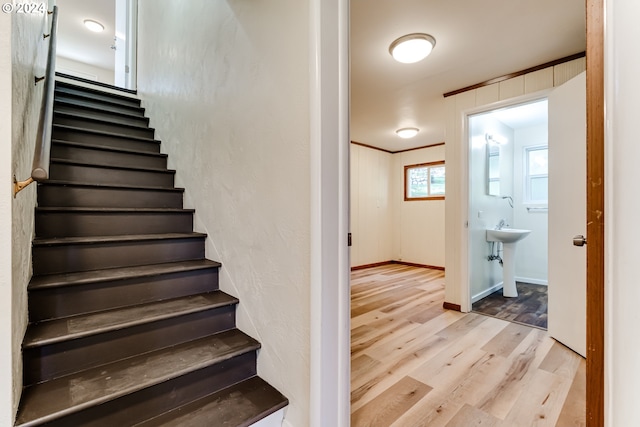 stairway featuring baseboards and wood finished floors