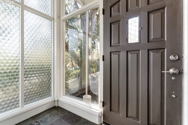 interior space featuring stone tile floors and a wealth of natural light