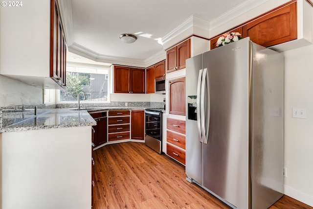 kitchen with light stone counters, stainless steel appliances, a sink, light wood finished floors, and crown molding