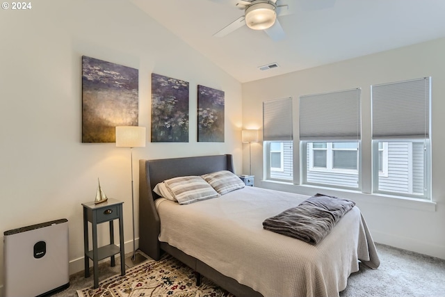 bedroom with light colored carpet, lofted ceiling, and ceiling fan