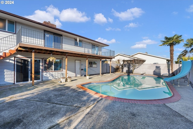 view of swimming pool with a patio area and a water slide