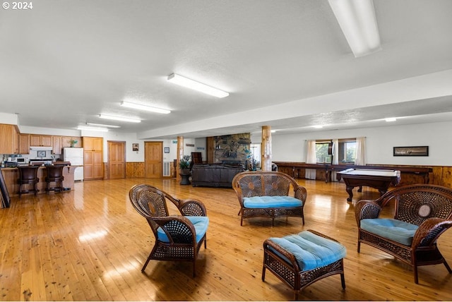 living room featuring light wood-type flooring and billiards