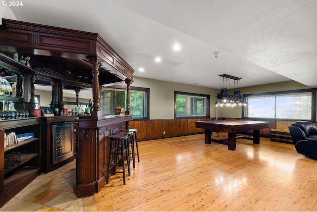 playroom with light hardwood / wood-style flooring, bar area, billiards, and beverage cooler