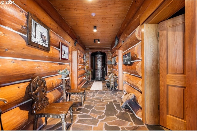 interior space with wood ceiling and rustic walls