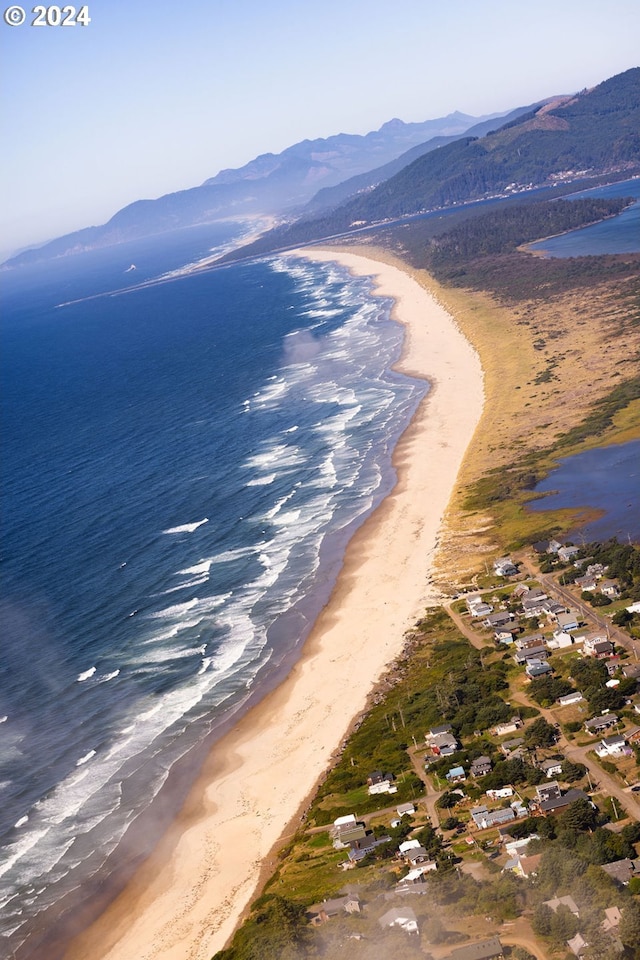 water view with a beach view and a mountain view