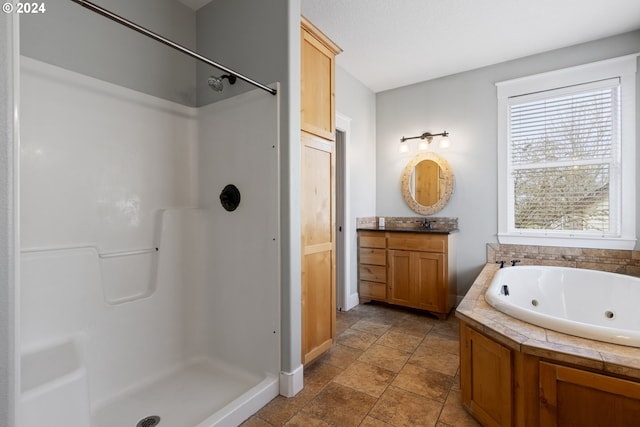 bathroom featuring vanity and independent shower and bath