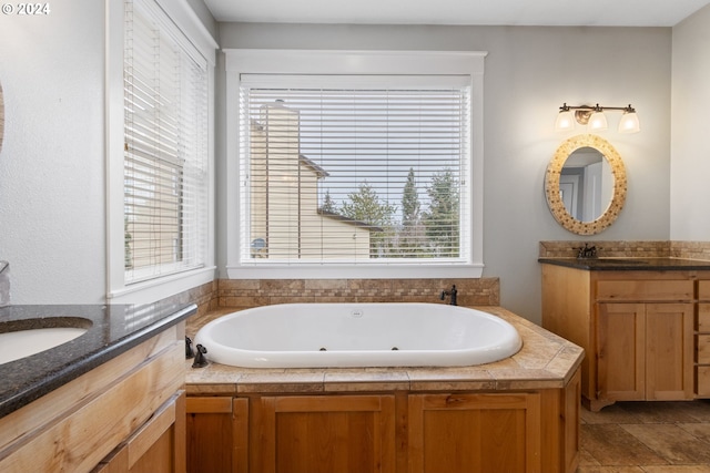 bathroom with vanity and a bath