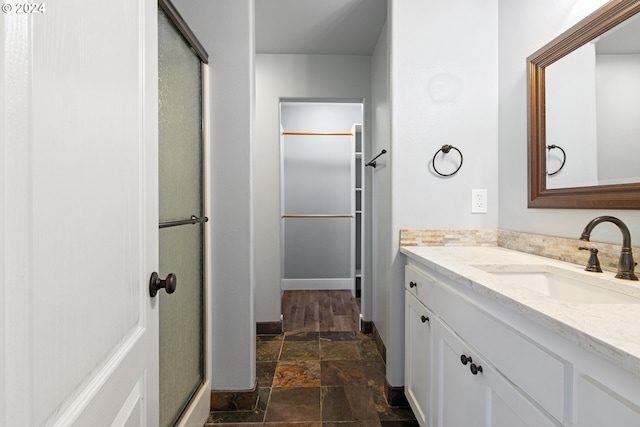 bathroom with vanity and a shower with shower door