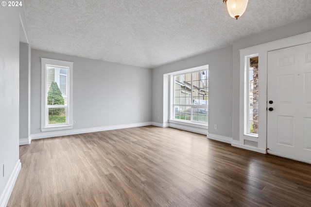 entryway with hardwood / wood-style floors and a textured ceiling