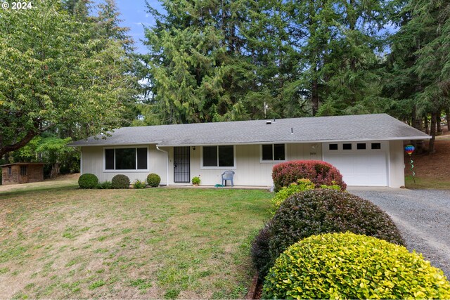 single story home featuring a front lawn and a garage