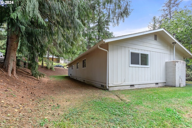 view of side of home with a yard