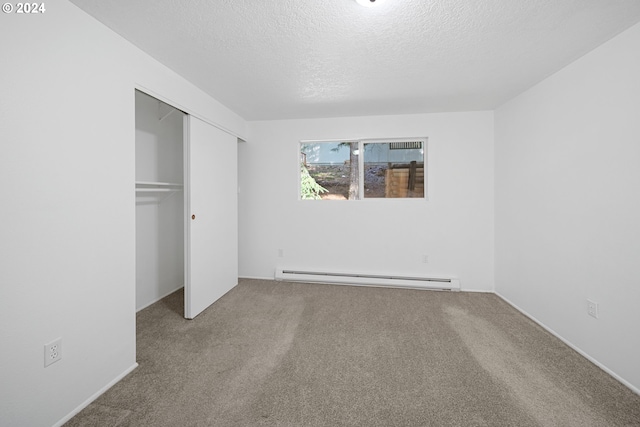 unfurnished bedroom with a baseboard radiator, a closet, a textured ceiling, and carpet