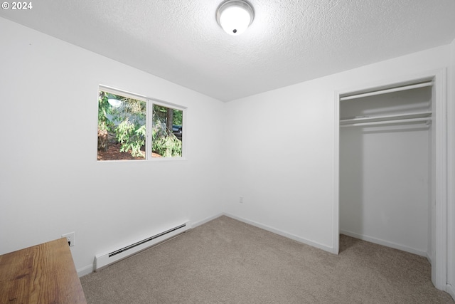 unfurnished bedroom with a baseboard radiator, a closet, light colored carpet, and a textured ceiling