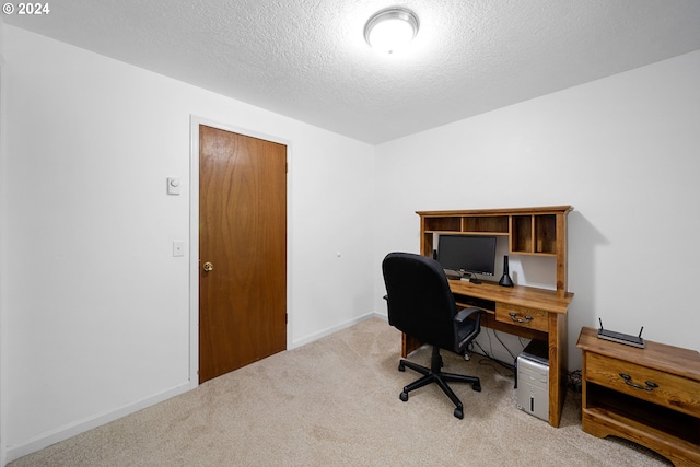 office with a textured ceiling and light carpet