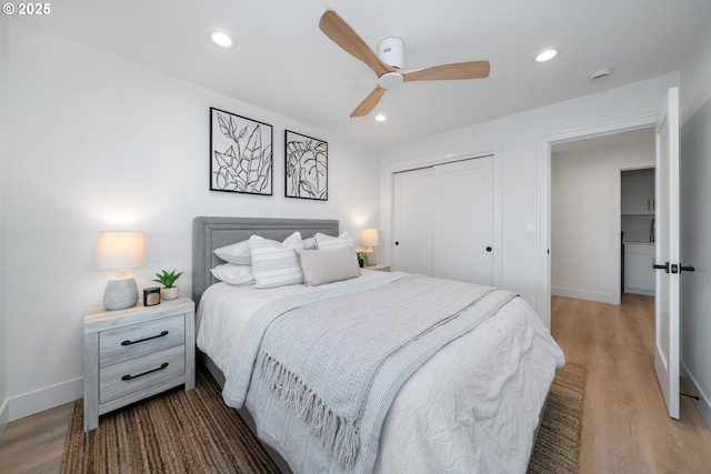 bedroom with ceiling fan, a closet, and wood-type flooring