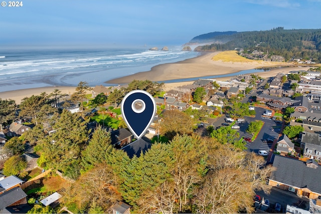 aerial view with a water view and a beach view