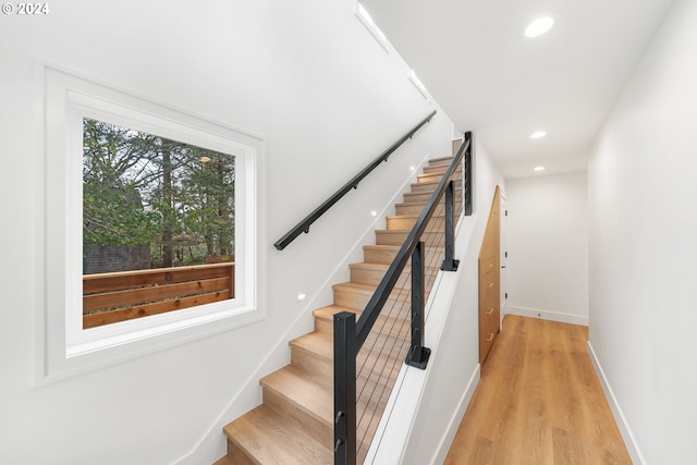 staircase with hardwood / wood-style flooring