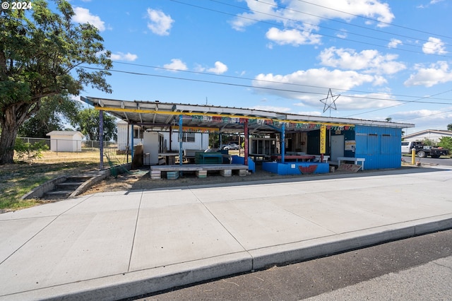 exterior space with a carport and a storage unit