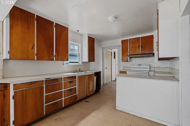 kitchen featuring white range oven and sink