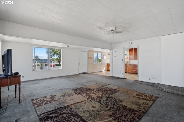 living room featuring carpet floors, plenty of natural light, and ceiling fan