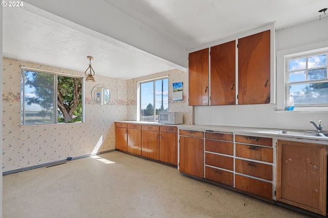 kitchen featuring decorative light fixtures and sink