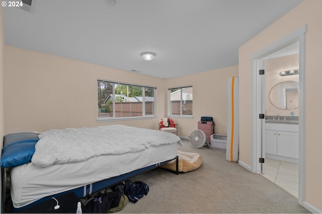 carpeted bedroom with connected bathroom