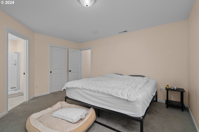 carpeted bedroom with connected bathroom