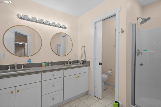 bathroom with walk in shower, vanity, and toilet