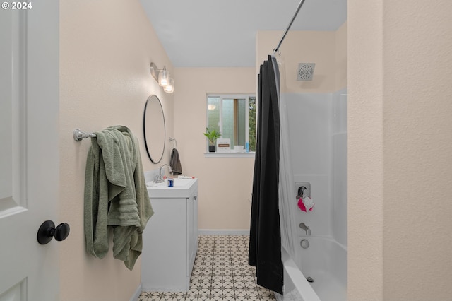 bathroom featuring shower / tub combo and vanity