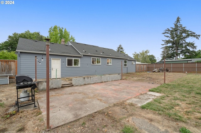 back of property featuring a patio and a yard