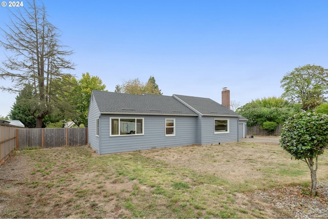 rear view of house with a lawn