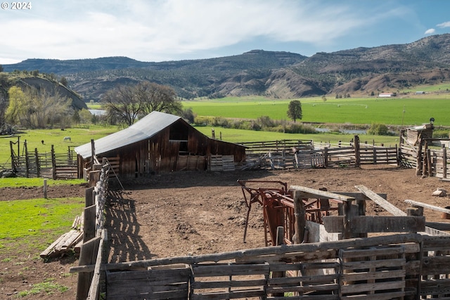 view of stable featuring a mountain view and a rural view